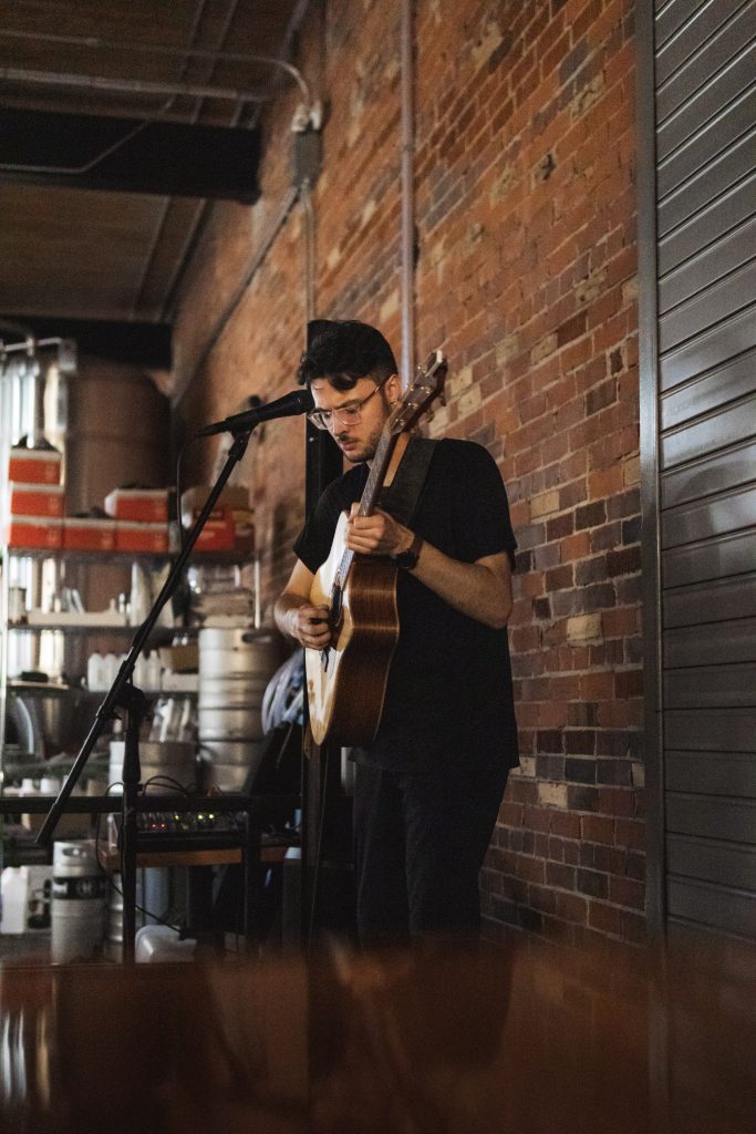 Playing guitar in a bar